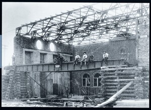 1906 men sitting on crane